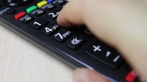 Human hand changes the channels on the TV remote control Stock Footage 69766613