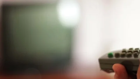 Human hand changes the channels on the TV remote control Stock Footage