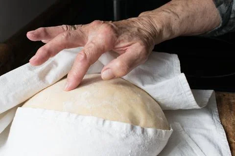 Human hand checking rising of yeast dought Stock Photos