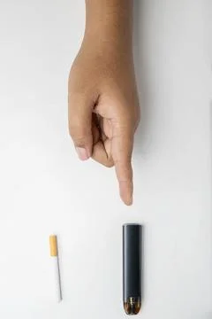 Human hand choose a cigarette, rolled tobacco in paper with a filter tube, .. Stock Photos