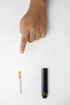 Human hand choose a cigarette, rolled tobacco in paper with a filter tube, .. Stock Photos