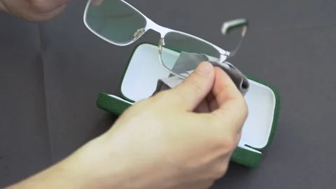 The Human Hand Cleans Glasses Cleaning Cloth, Close up. Stock Footage 130314927