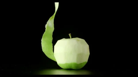 Human hand cleans a green apple (a spiral) Stock Footage 62364940