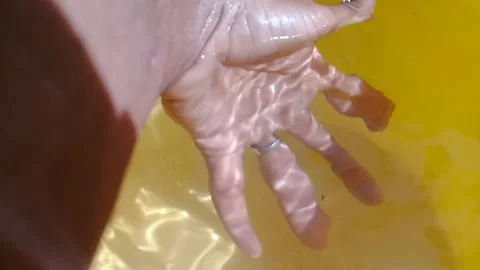 A human hand in clear water Stock Footage 169835741