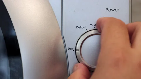 The Human Hand Closes The Door Of The Microwave Oven And Sets Its Operating Mode Video stock 248561029