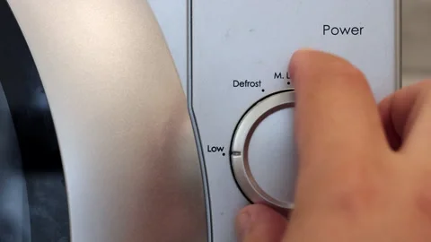 The Human Hand Closes The Door Of The Microwave Oven And Sets Its Operating Mode Video stock 248561036