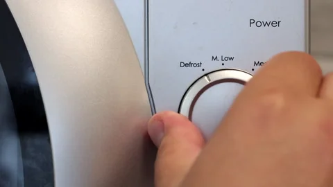 The Human Hand Closes The Door Of The Microwave Oven And Sets Its Operating Mode Video stock 253438738