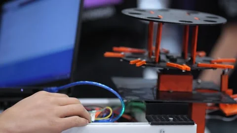 Human hand connects cables to 3D printer Stock Footage 345700785