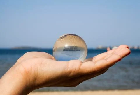 Human hand with crystal globe Foto stock