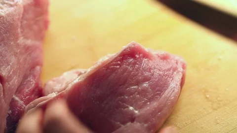 Human hand cutting a fresh piece of pork Stock Footage 71641376