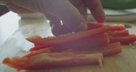 Human hand cutting red bell pepper Stock Footage 306300691