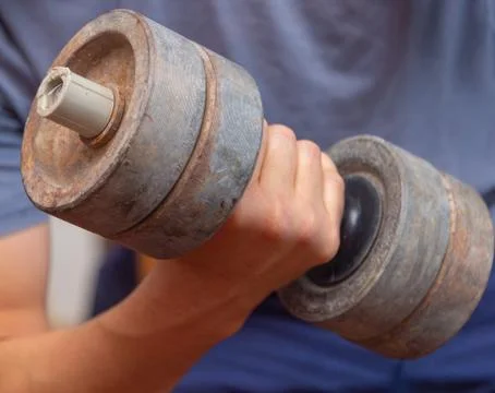 Human hand with dumbbell Stock Photos