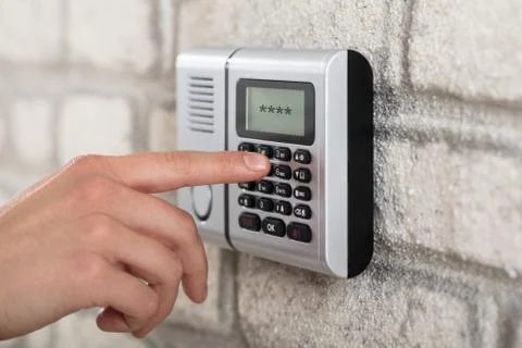 Human Hand Entering Security System Code Stock Photos