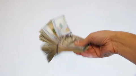 Human hand fanning stack of paper currency indoors Stock Footage 331514516