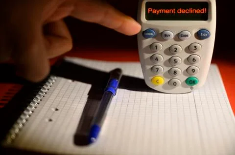 Human hand finalizing contactless card reader purchase payment decline messag Stock Photos