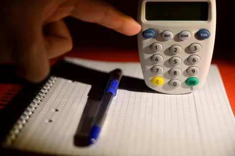 Human hand finalizing contactless card reader purchase with pen and notebook  Stock Photos