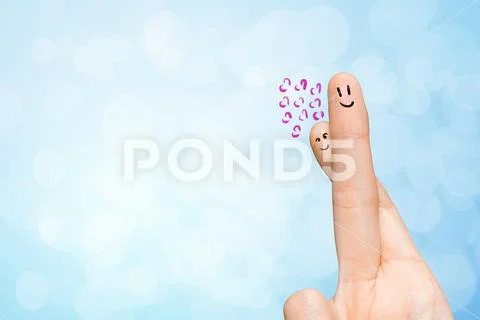 Human hand fingers with funny painted emoticons. People relationships concept Stock Photos