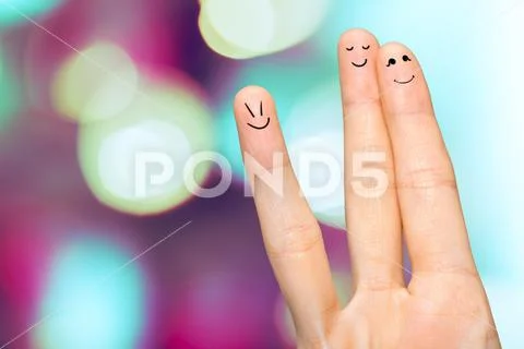 Human hand fingers with funny painted emoticons. People relationships concept Stock Photos