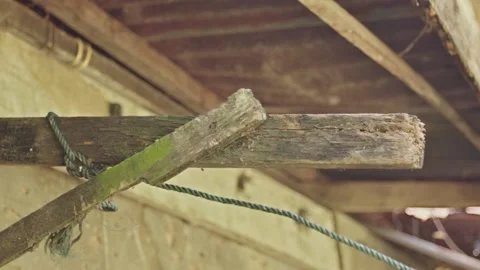 Human hand fixing blue clothesline wrap on old wood, Repairing laundry line.. Stock Footage 330050793