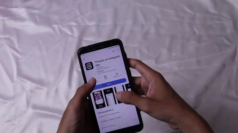 Human hand gestures downloading the threads application, an Instagram Stock Footage 245523968