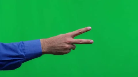 Human hand on a green background isolate, the person shows two fingers. Stock Footage 168835522
