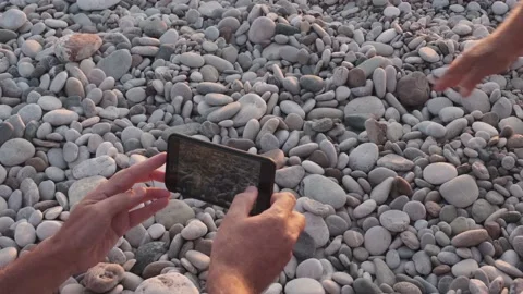 Human hand helps turtle crawling toward on stones to sea 스톡 동영상 130750504