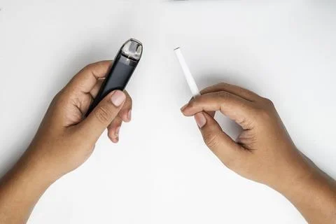 Human hand holding a cigarette, rolled tobacco in paper with a filter tube,.. Stock Photos