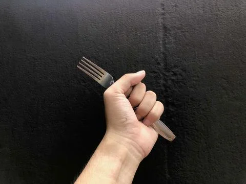 Human hand holding a fork Stock Photos