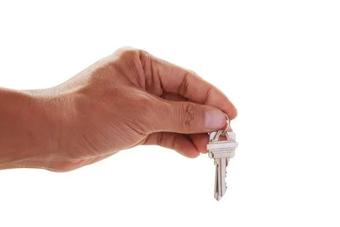 Human hand holding key to a dream house isolated on white Stock Photos