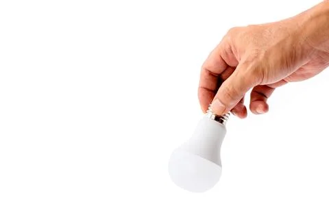 Human hand holding LED light bulb isolated on white background. Stock Photos