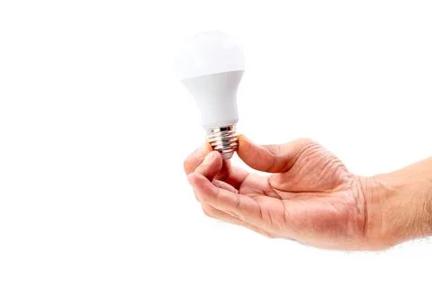 Human hand holding LED light bulb isolated on white background. Stock Photos
