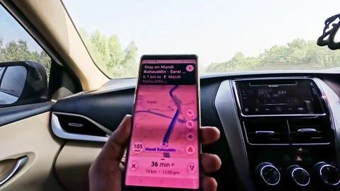 Human hand holding mobile phone with location app open, while travelling. Stock Footage 341163009