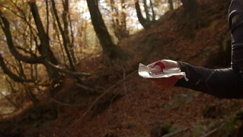 Human hand holding orienteering map and compass in sunny autumn forest. Camera Video stock 167336358