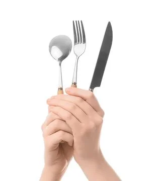 Human hand holding silverware set with spoon, fork, and knife, kitchen utensi Stock Photos