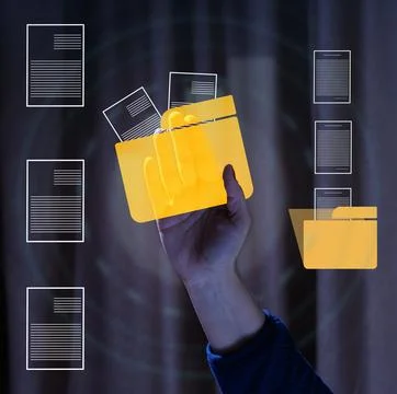 Human hand holding translucent yellow digital folder with documents on dark.. 스톡 사진