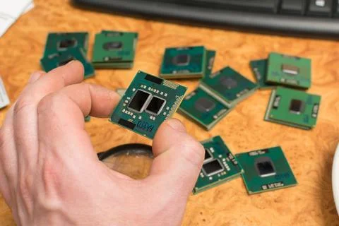 A human hand holds a microprocessor from a computer Stock Photos