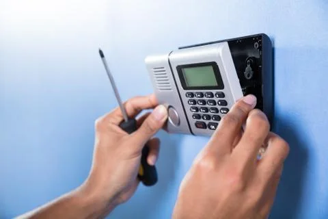 Human Hand Installing Security System Stock Photos
