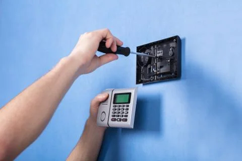 Human Hand Installing Security System Stock Photos