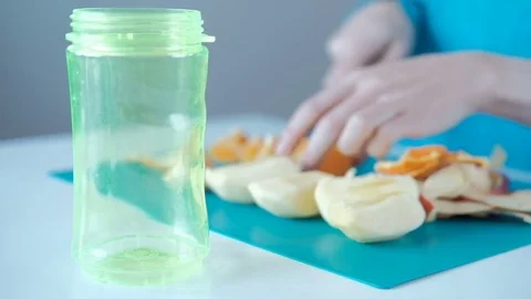 Human hand with a knife cut fruit for that would put in the bank Stock Footage 73226887
