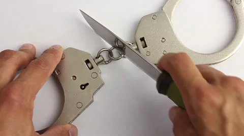 Human hand with a knife cuts the chain of the handcuffs Video stock 24615445