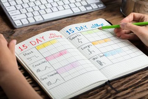 Human Hand Making Exercise Plan On Notebook Foto stock