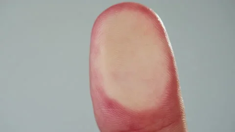 Human hand making fingerprint on grey background. Person pressing finger on Stock Footage 182021336