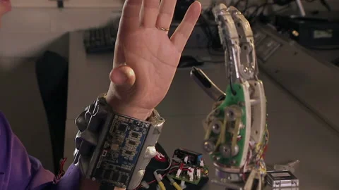 Human hand moving robotic hand, experimenting with robotic arms Stock Footage 202909254