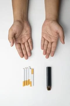 Human hand offering cigarettes, rolled tobacco in paper with a filter tube,.. Stock Photos