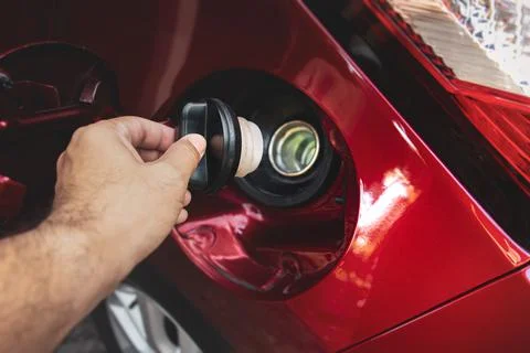Human hand is open or close fuel tank cap Stock Photos