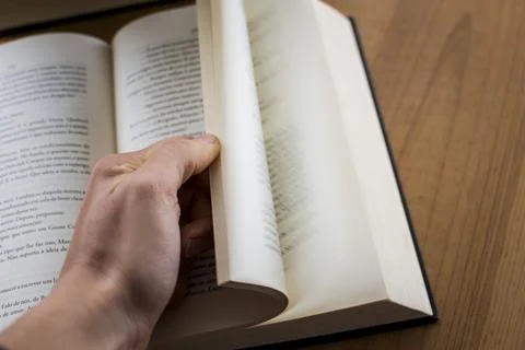 Human hand opening a book Stock Photos