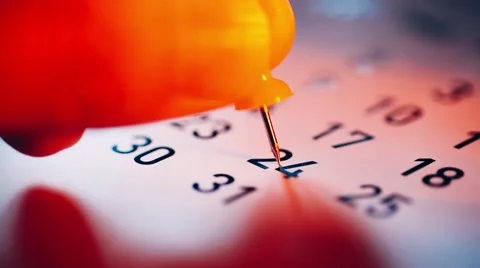 Human hand placing a push pin on calendar Stock Footage 49325973