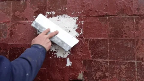 Human hand plastering red building wall outdoors. Stock Footage 231798810