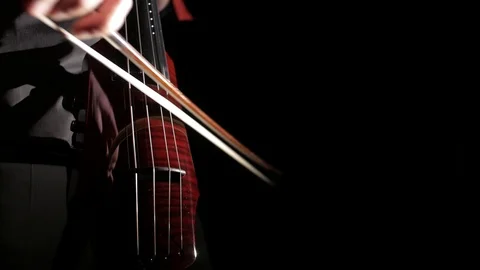 Human hand playing electric cello, close-up of strings, bow and fingerboard Vídeo Stock 107871874