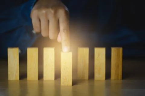 Human hand points at the front blocks wood  tor show influence and leadership Stock Photos